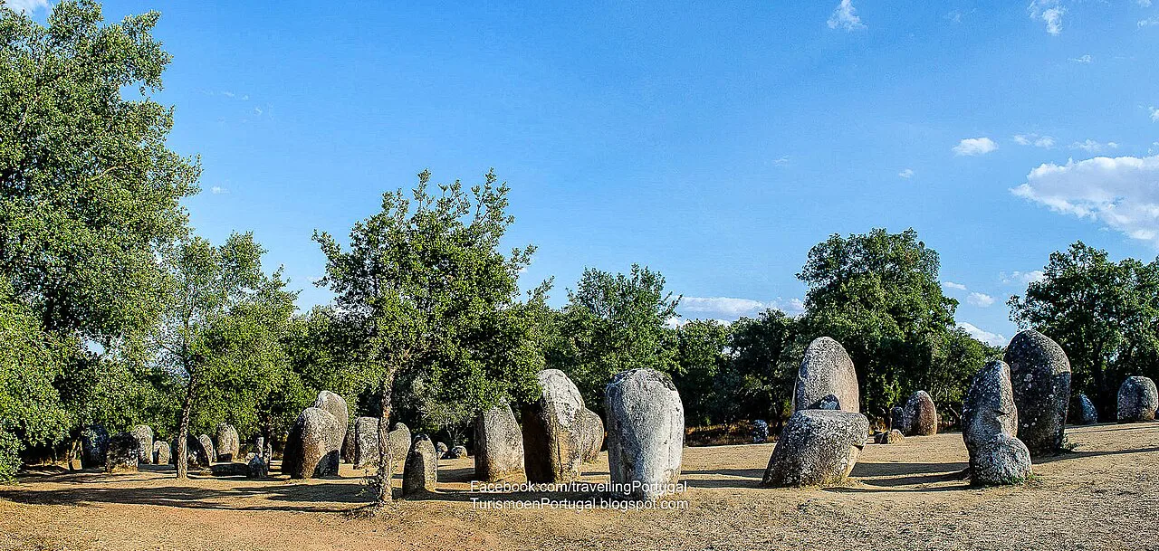 The megaliths of the Almendres Cromlech among cork oaks near Évora.