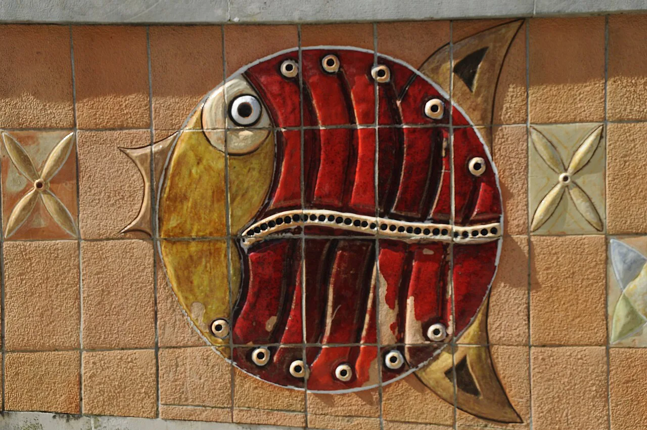 A tiled fish mural set into a wall in Aveiro.