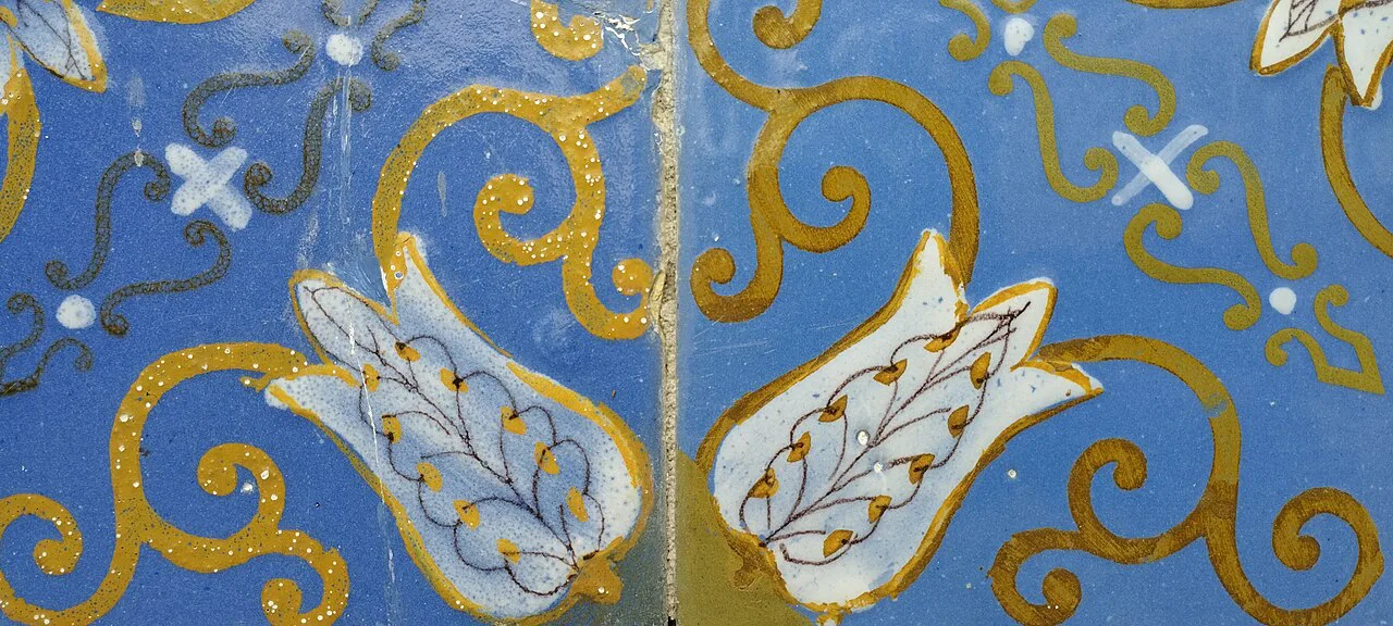 Blue and yellow tin-glazed tiles on a façade in Braga.