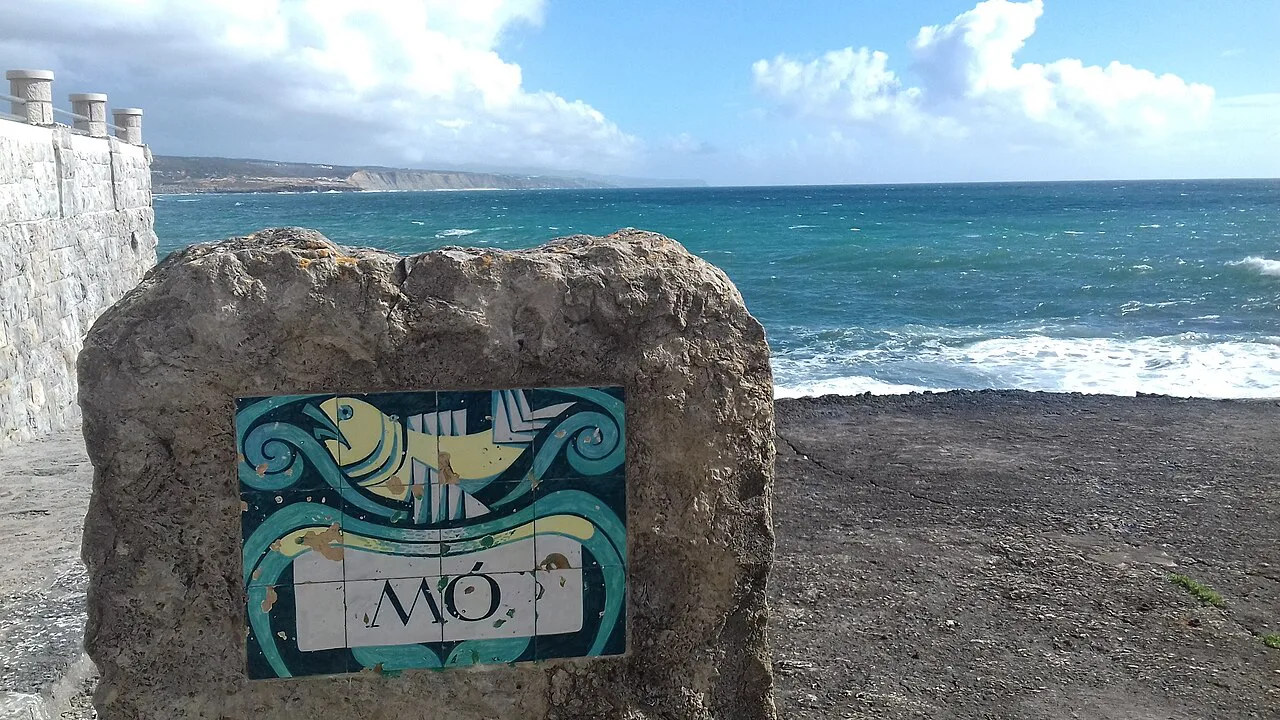 A tile panel by Kradolfer set on a rock above the sea in Ericeira.