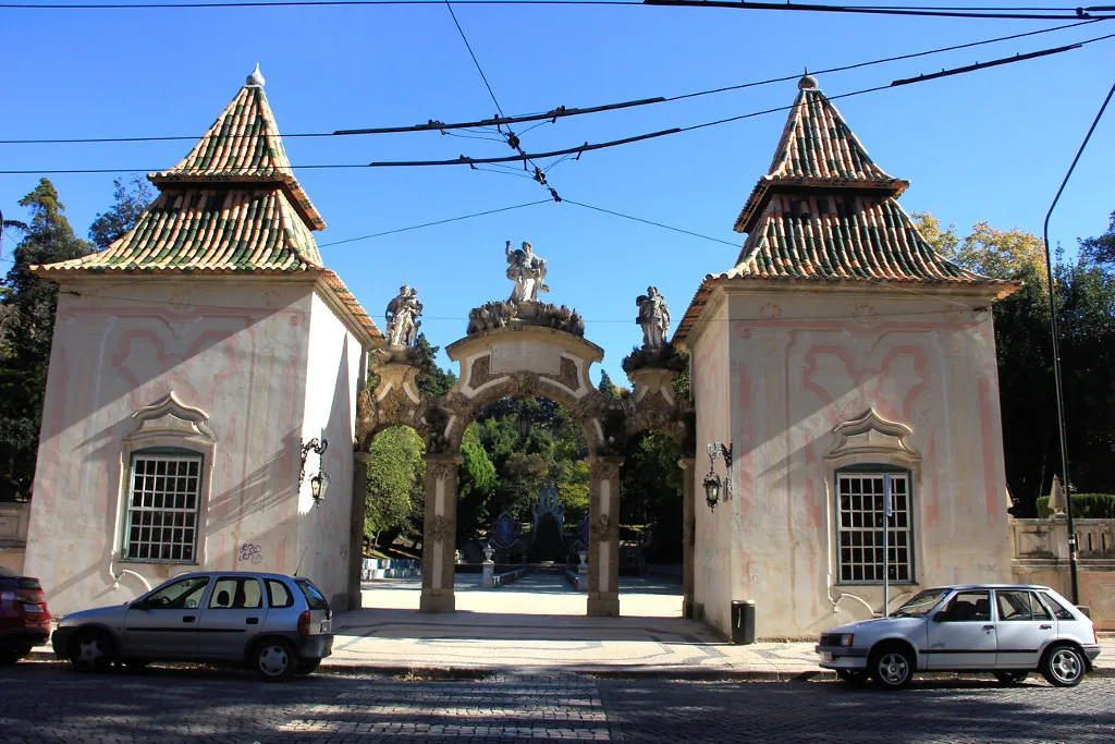 An ornate gateway between two pavilions in Coimbra.