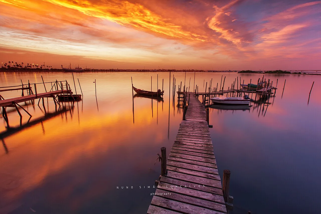 The old wooden pier at Barra on the Ria de Aveiro at sunset.