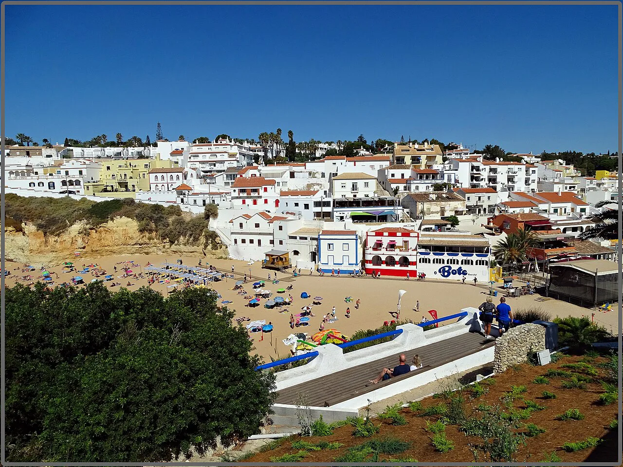 A view over Carvoeiro, with white houses above the beach.