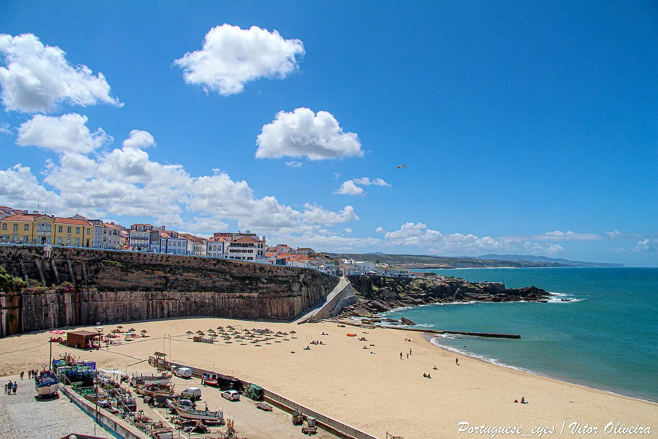 The beach at Ericeira below the town's clifftop houses.
