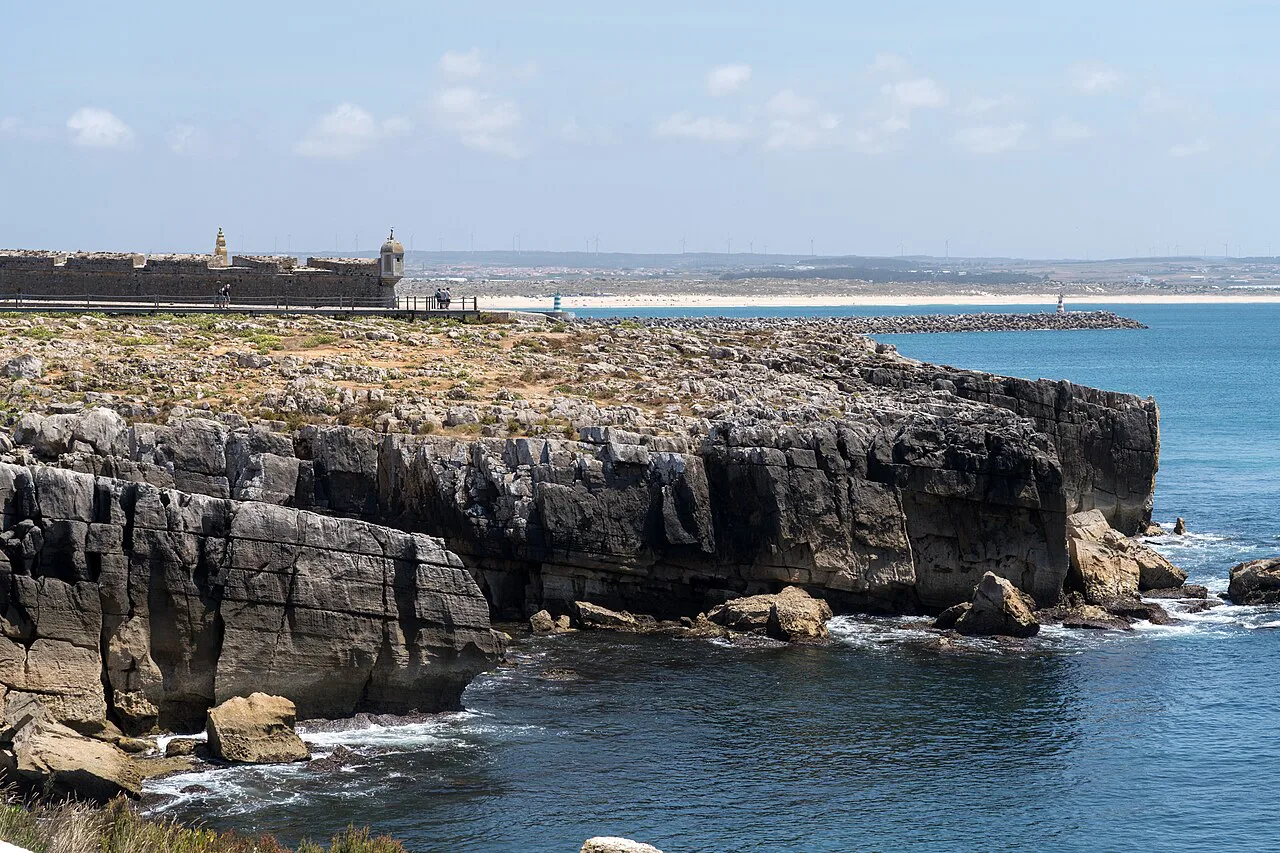 Peniche's rocky coastline with the fortress in the distance.