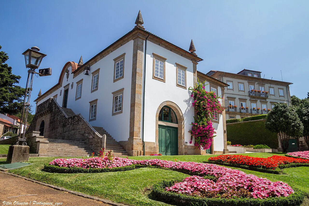 The Câmara Municipal de Ponte de Lima, with flower beds in the garden in front.