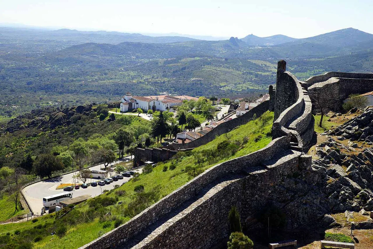 The walls of Marvão running along the hilltop above the Alentejo countryside.