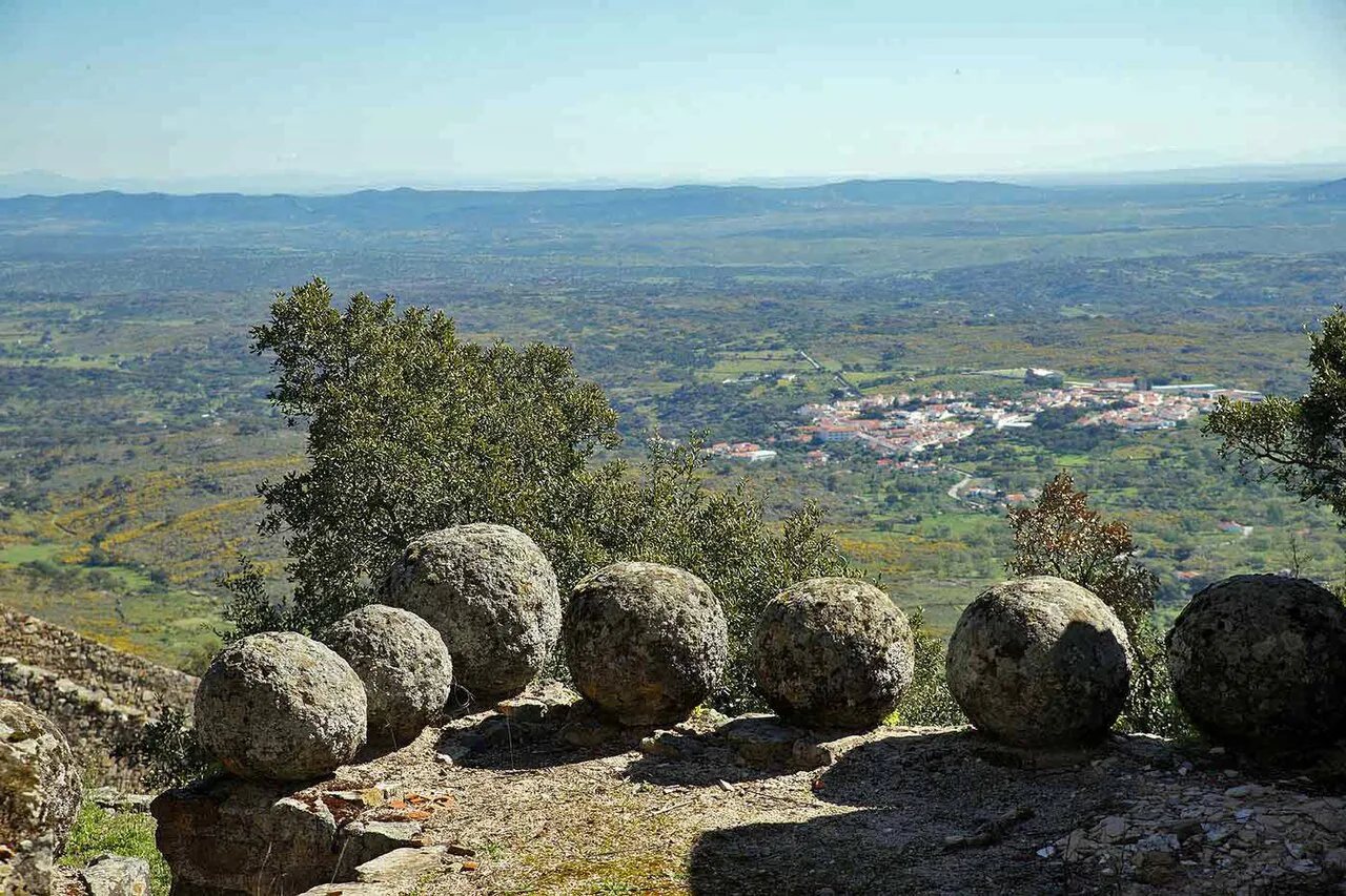 Stone balls on a terrace in Marvão, with the countryside of Portalegre district below.