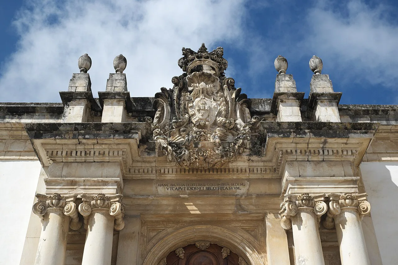 The carved coat of arms above the portal of the Biblioteca Joanina in Coimbra.