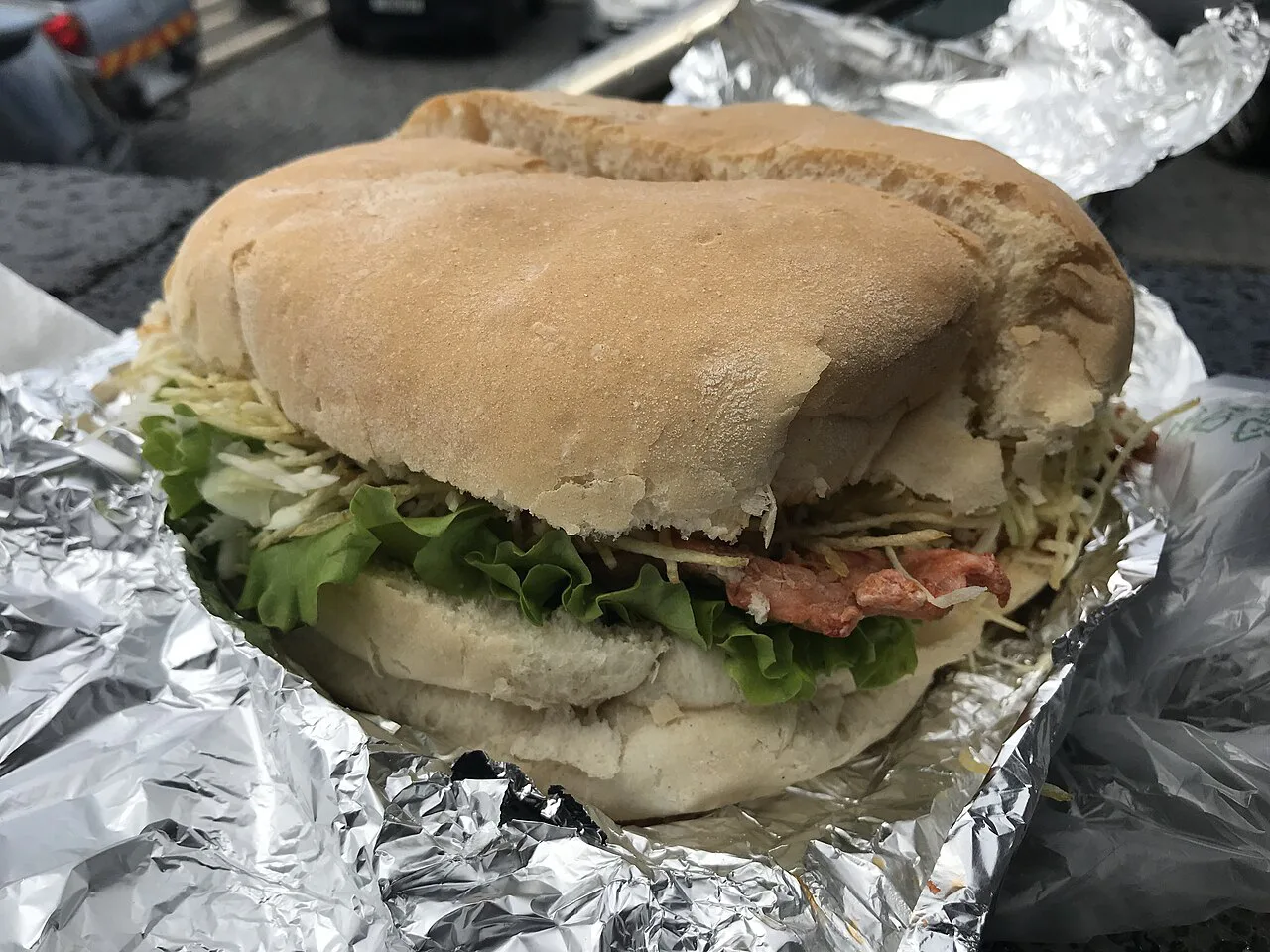 A bifana, the Portuguese marinated pork sandwich, served in a bread roll.