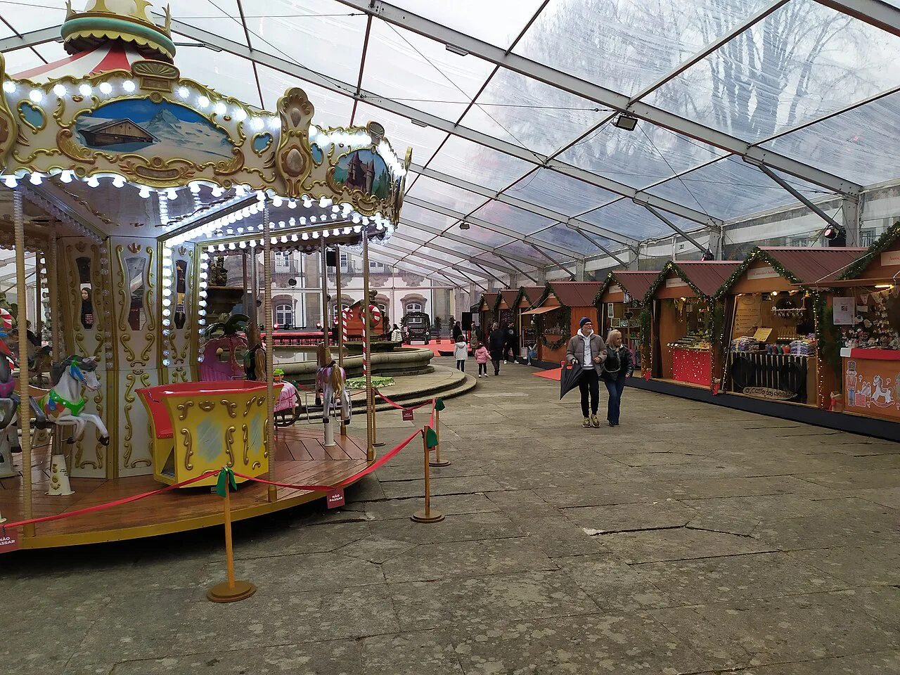 Stalls and a carousel at the Christmas market in Braga.