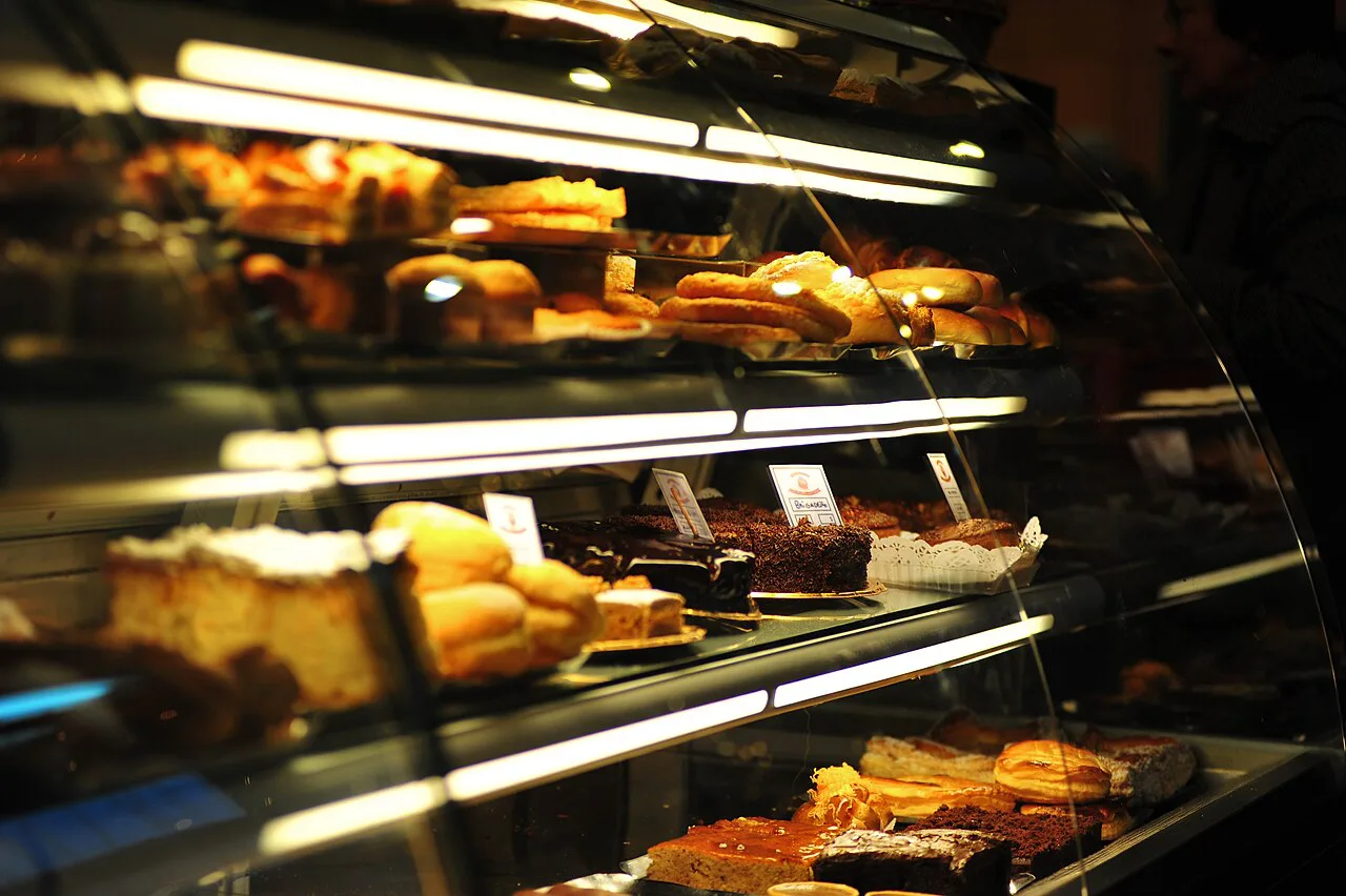 A café display case filled with pastries in Braga.