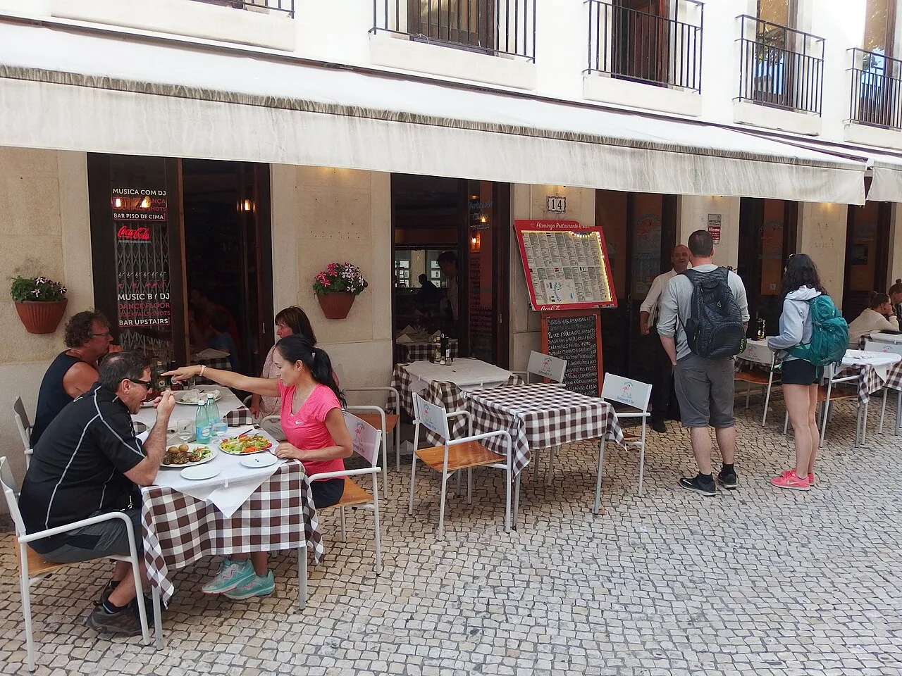 Outdoor restaurant tables on a pedestrian street in Cascais.