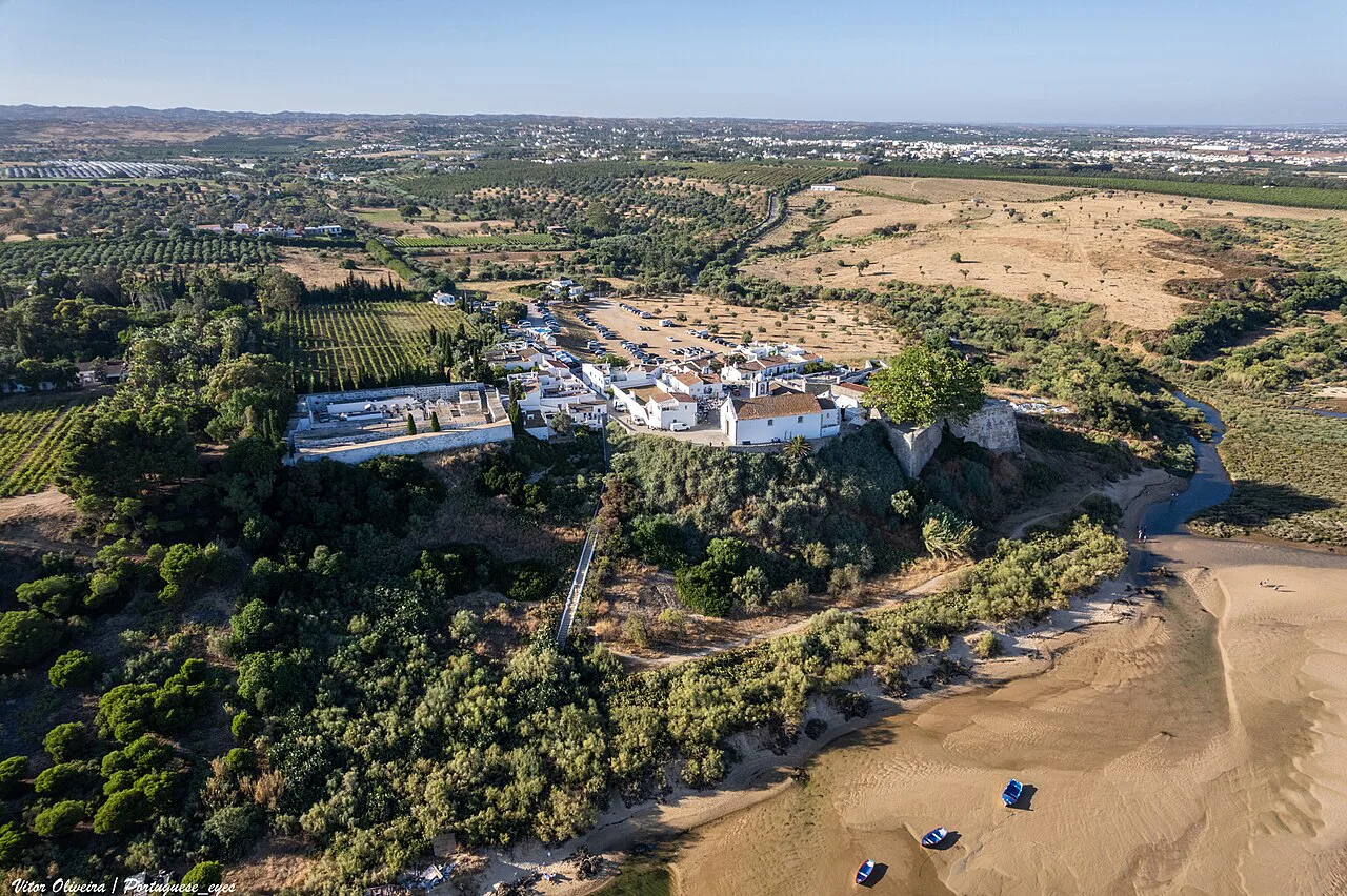 Aerial view of the clifftop village of Cacela Velha above the dunes.
