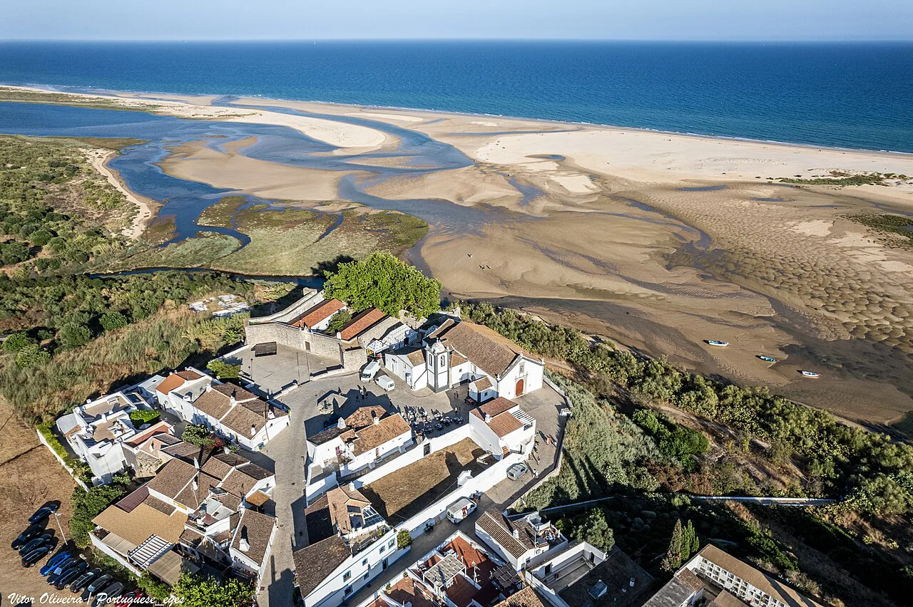 Aerial view of Cacela Velha with the Ria Formosa lagoon and the sea beyond.