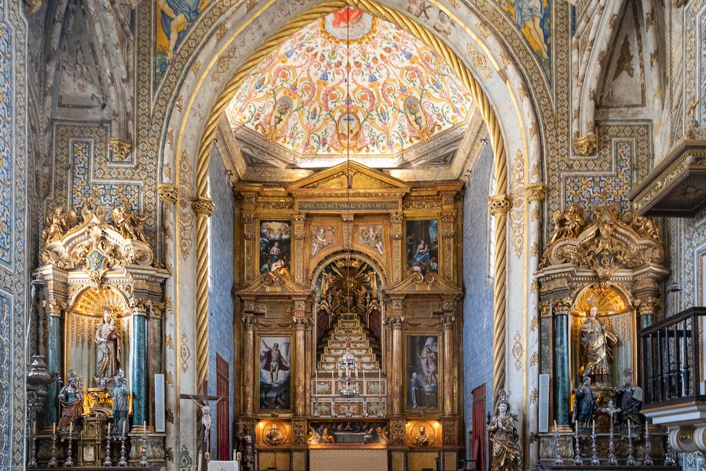 The gilded altar and painted ceiling of the São Miguel Chapel at the University of Coimbra.