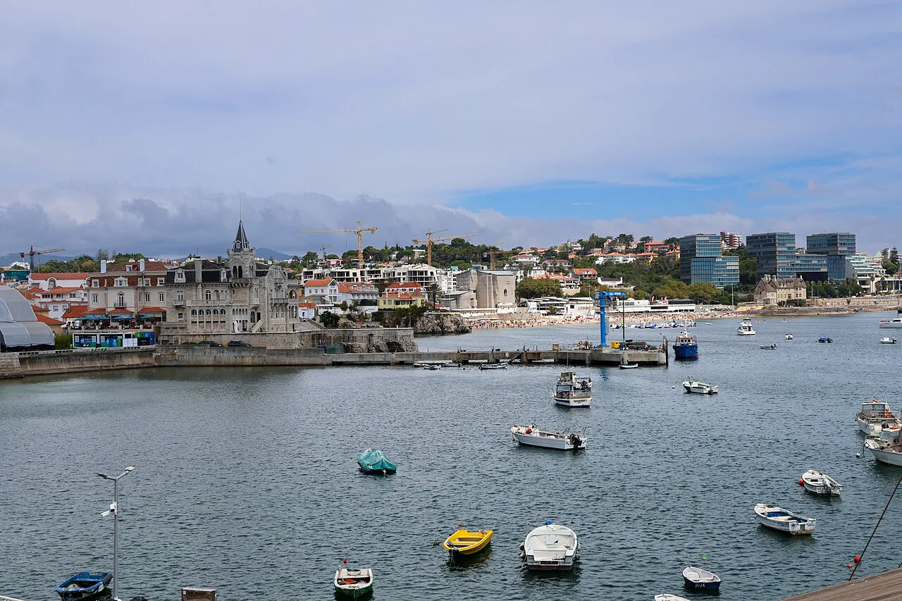 Boats moored in the bay at Cascais, with the town behind.