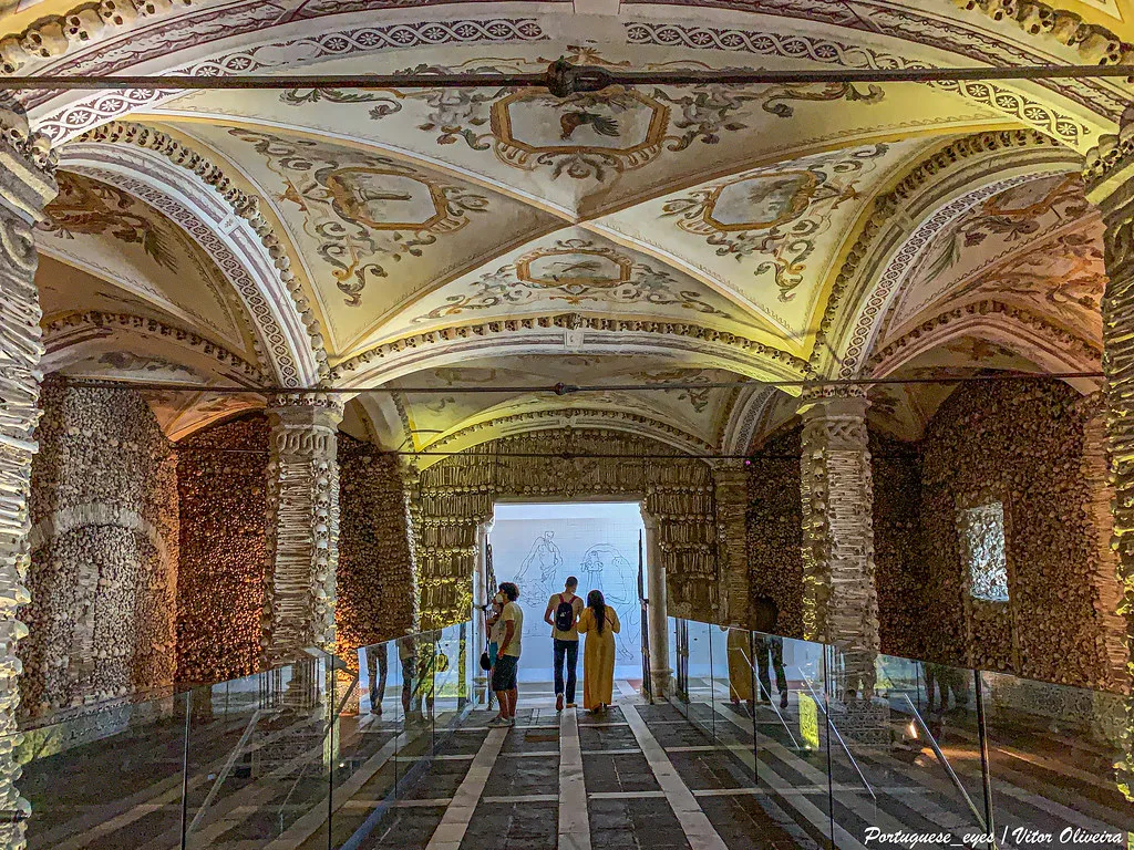 Bone-lined walls and painted vaulting inside the Capela dos Ossos in Évora.