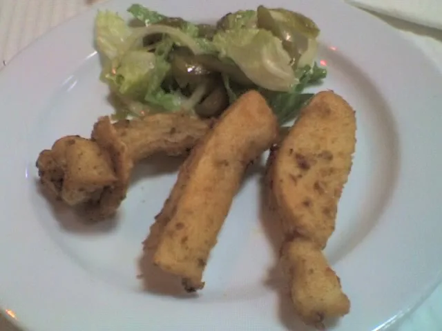 A plate of choco frito, fried cuttlefish, served with salad.