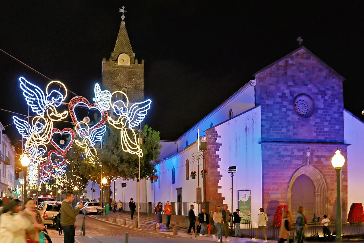 Funchal Cathedral lit up with Christmas decorations at night.