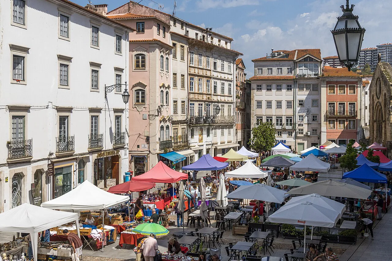 Stalls at the flea market on Praça do Comércio in Coimbra.