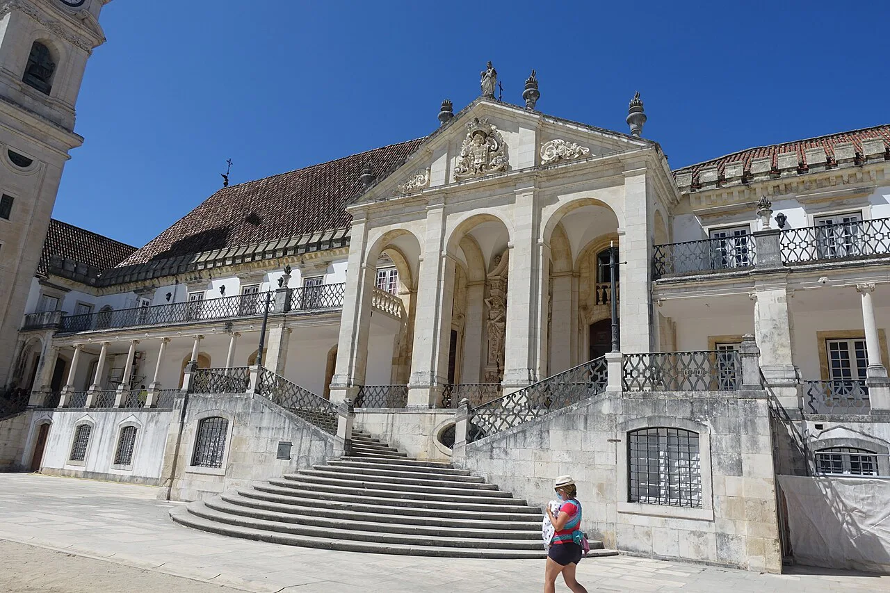 A historic building with a stone staircase in Coimbra.