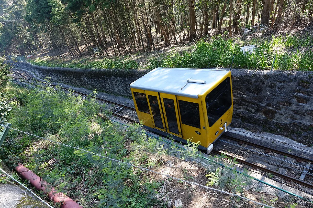 The yellow car of the Santa Luzia funicular climbing the hill in Viana do Castelo.