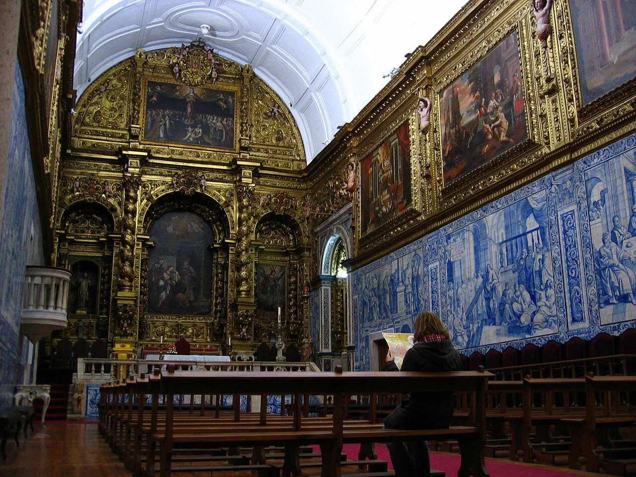 The gilded altar and azulejo-lined walls inside the Misericórdia Church in Évora.
