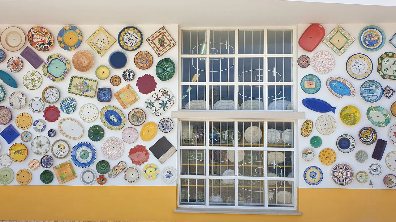 Painted ceramic plates covering the wall of a pottery shop in Sagres.