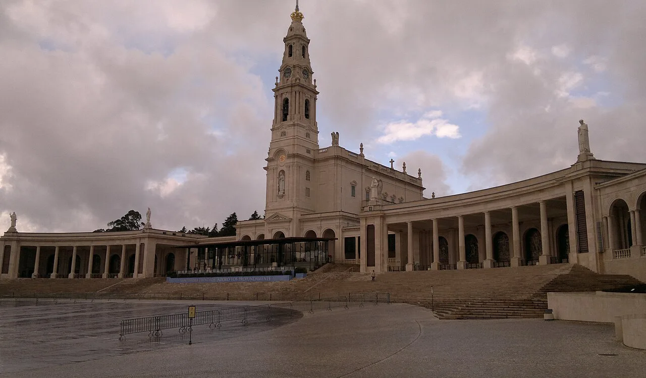 The basilica tower and curved colonnade at the Sanctuary of Our Lady of Fátima.