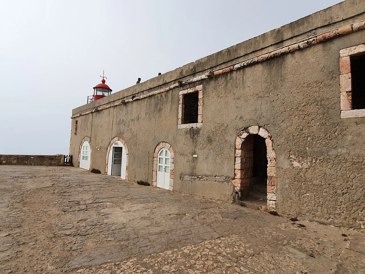 The stone walls and lighthouse of the Forte de São Miguel Arcanjo in Nazaré.