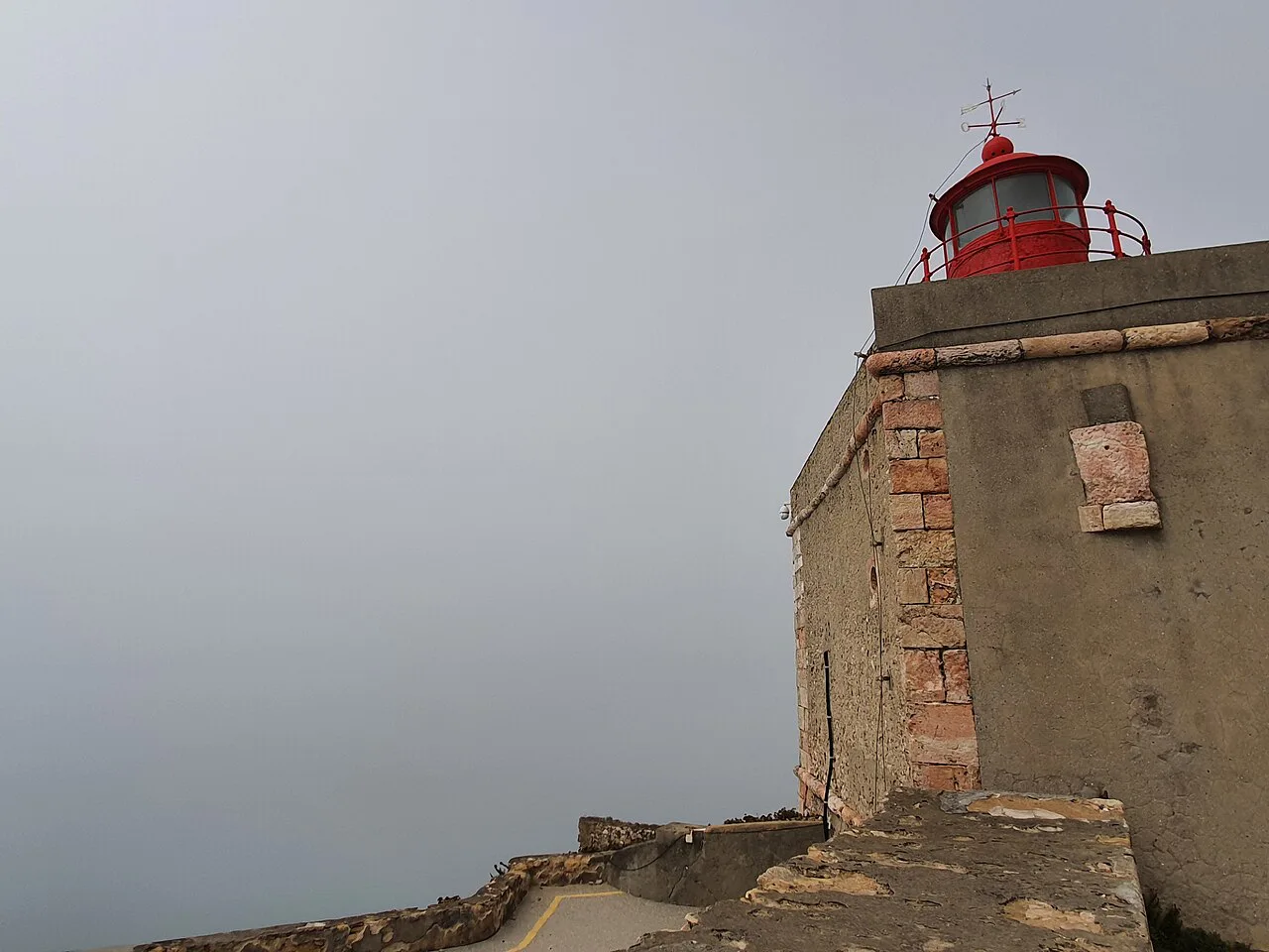 The walls and red lighthouse lantern of the Forte de São Miguel Arcanjo in Nazaré.