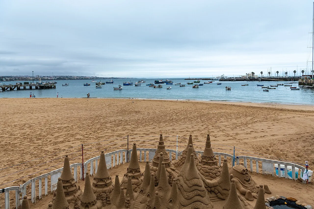 Sand sculptures on a beach in Cascais, looking out over the bay.