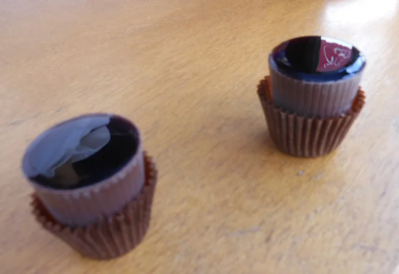 Ginjinha cherry liqueur served in small chocolate cups.