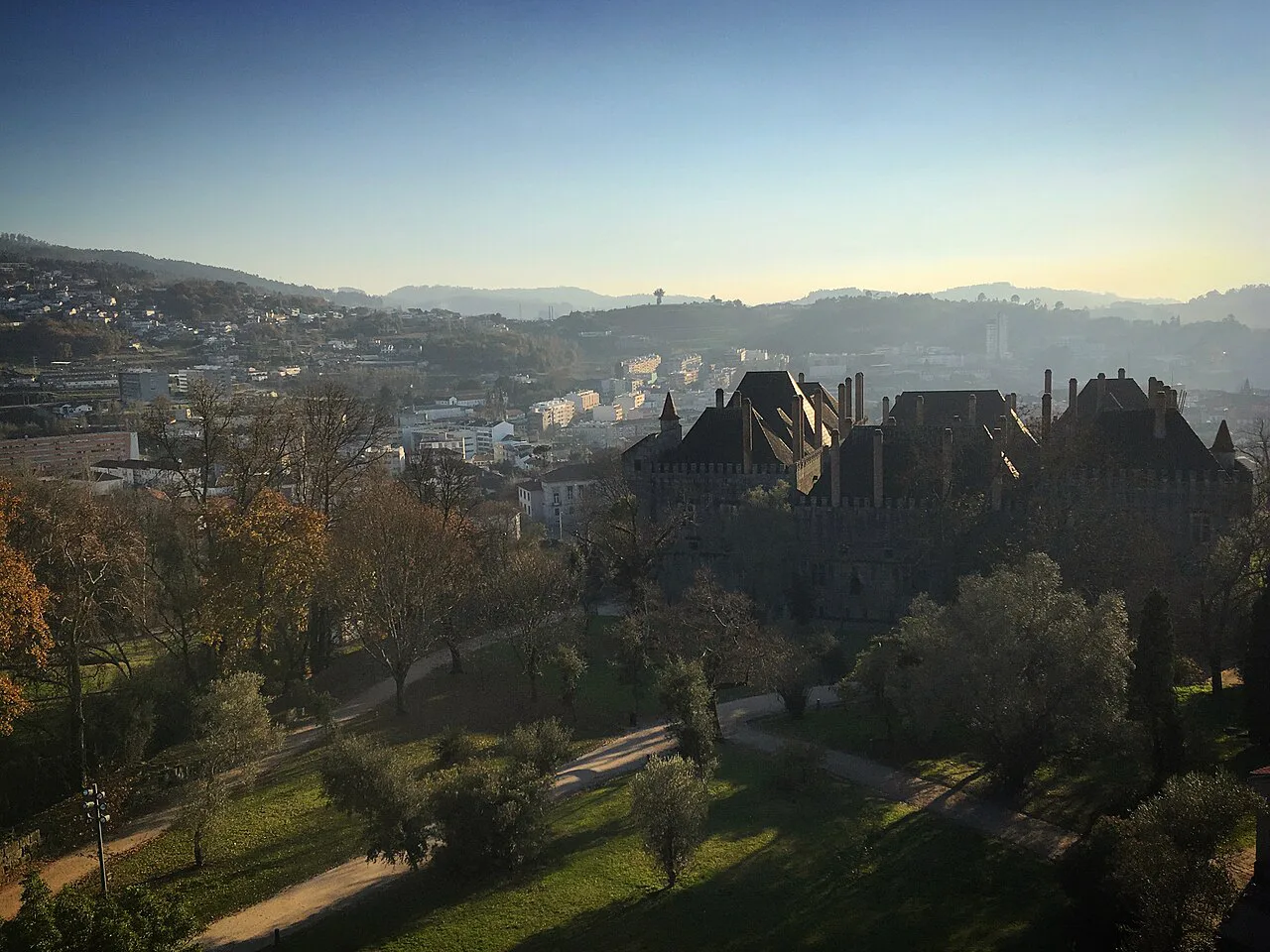 Evening view over parkland and rooftops in Guimarães.