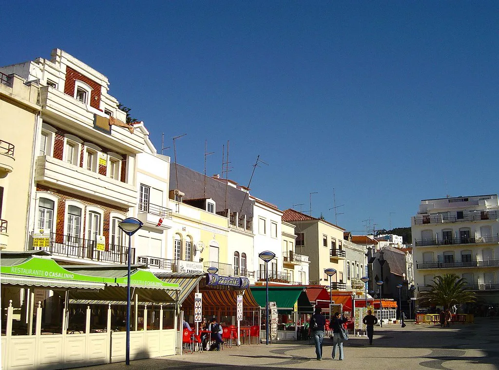 Buildings and café awnings along a street in Nazaré.