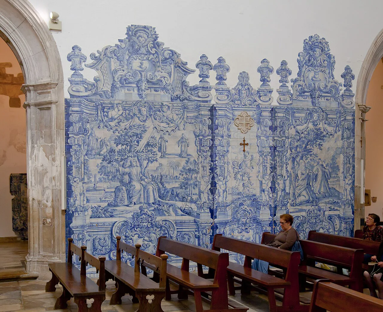 Blue and white azulejos lining a wall in the Monastery of Santa Cruz in Coimbra.