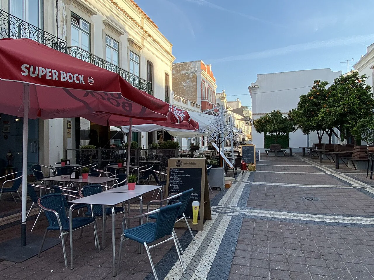 Café terraces along a pedestrian street in Faro.