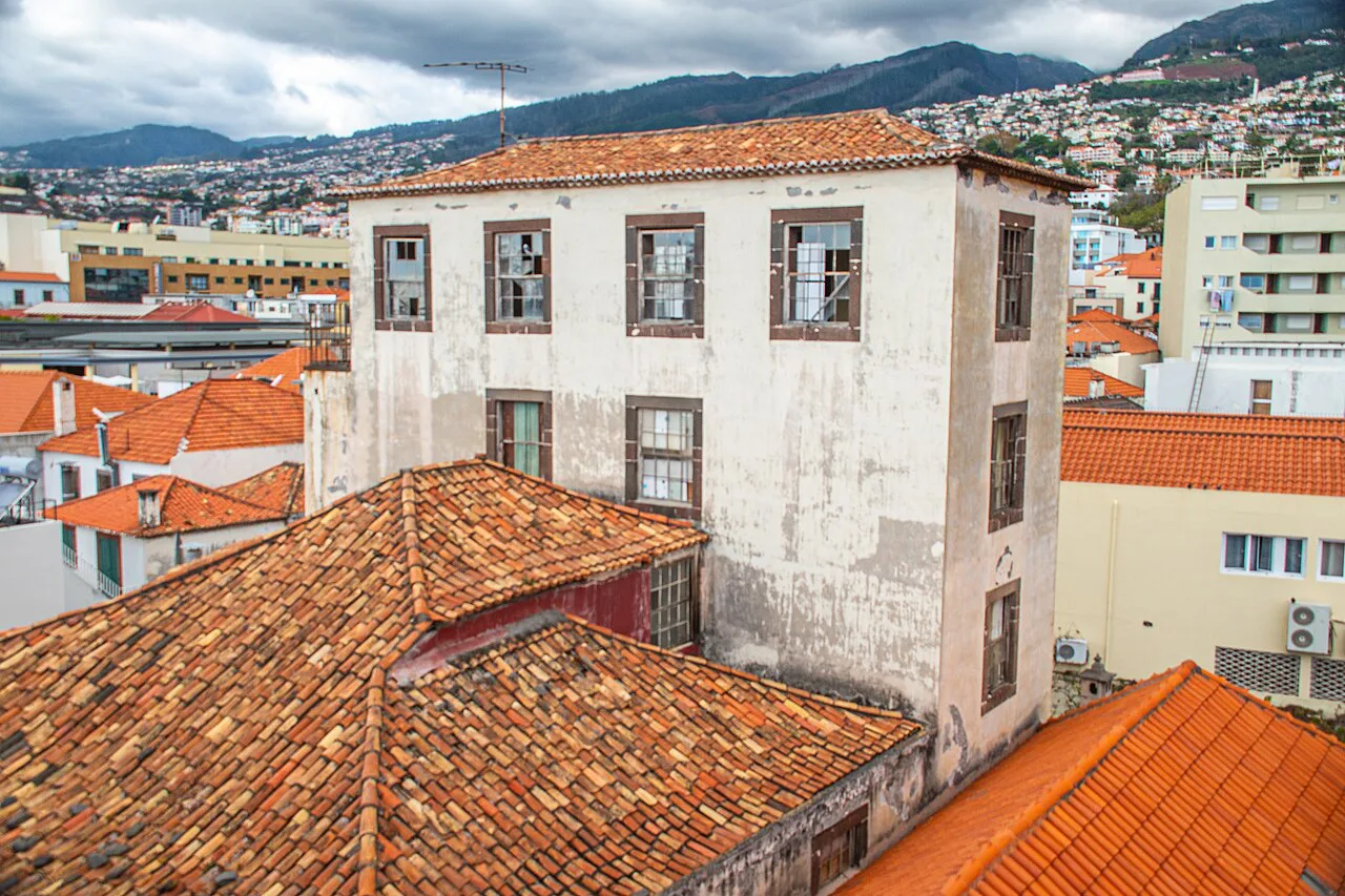 Terracotta rooftops and the hillsides of Funchal seen from the Madeira Story Centre.