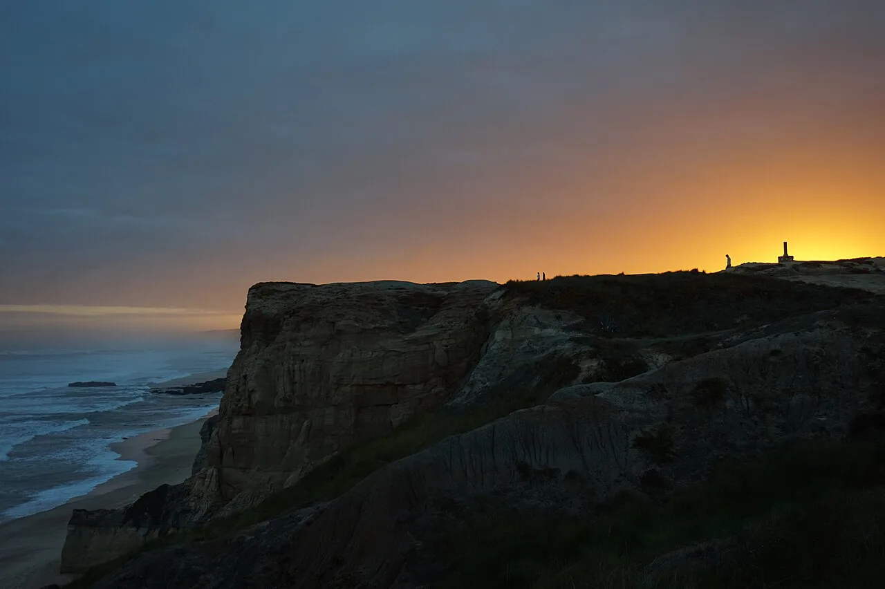 A sea cliff at Peniche silhouetted against the sunset.