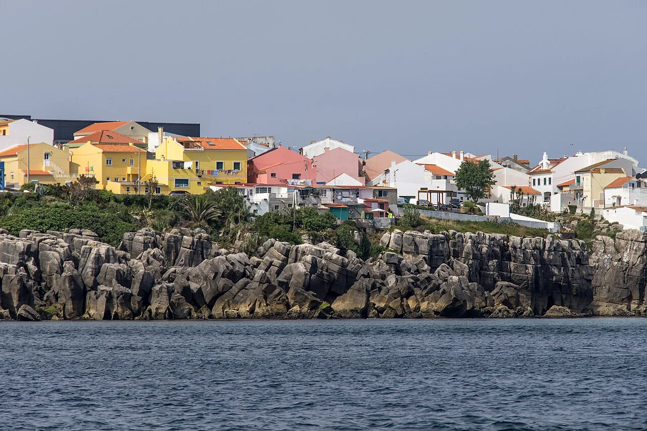 Colourful houses above the rocky coast of Peniche.