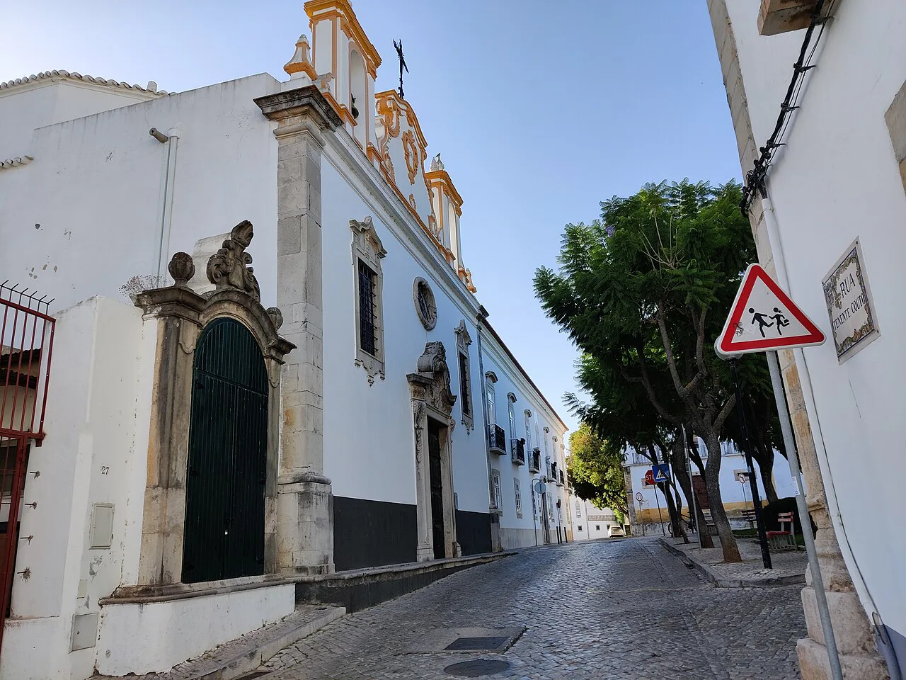 A whitewashed street and church facade in Tavira.