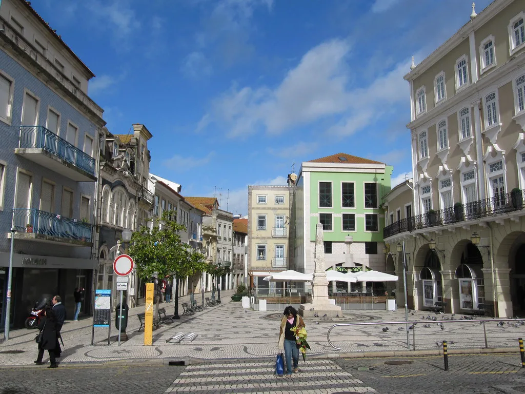 A pedestrian street with a zebra crossing and old buildings in central Aveiro.