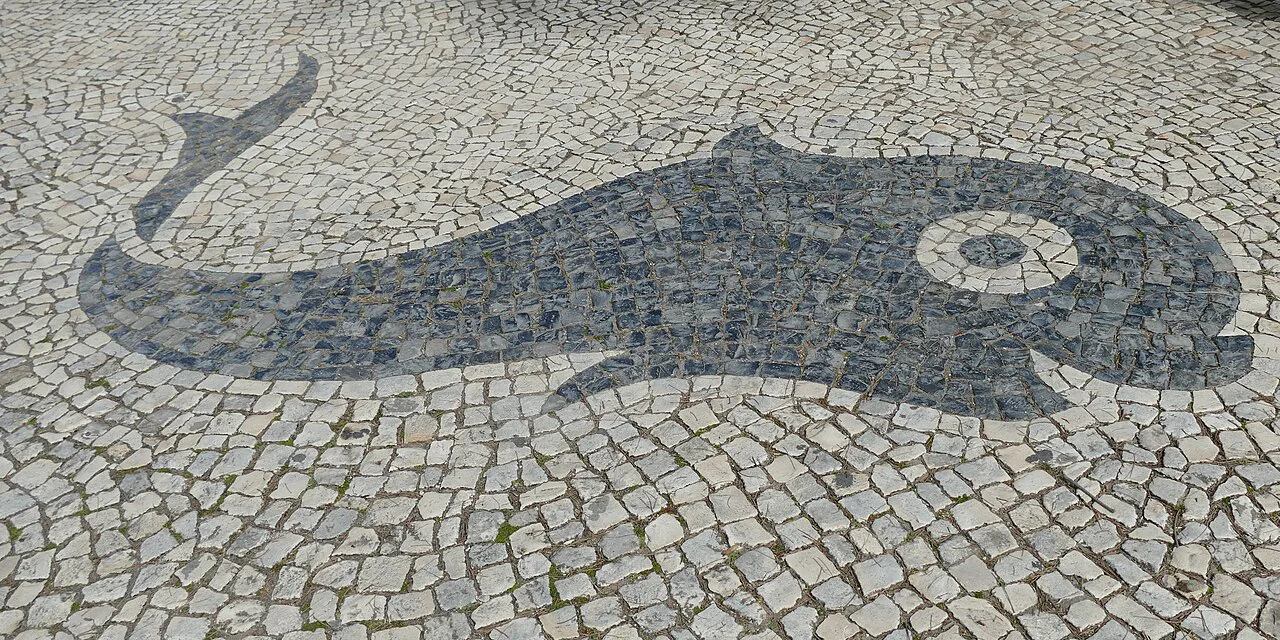 A cobblestone mosaic of a dolphin in the Jardim Manuel Bívar in Faro.