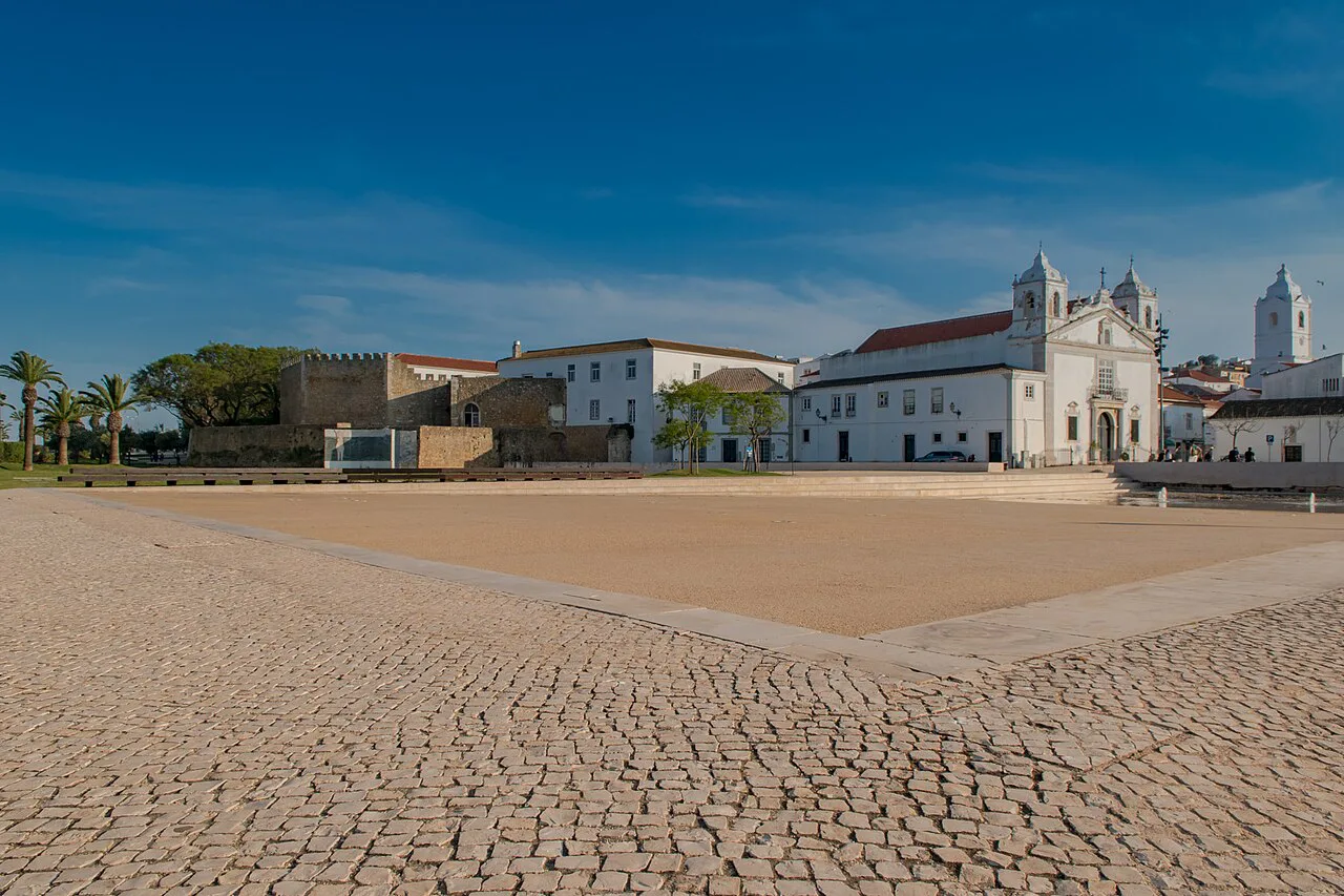A cobbled square in Lagos old town with a church in the background.