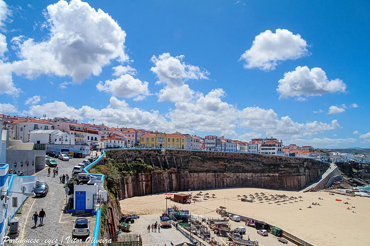 The harbour beach at Ericeira, with the town above the cliffs.