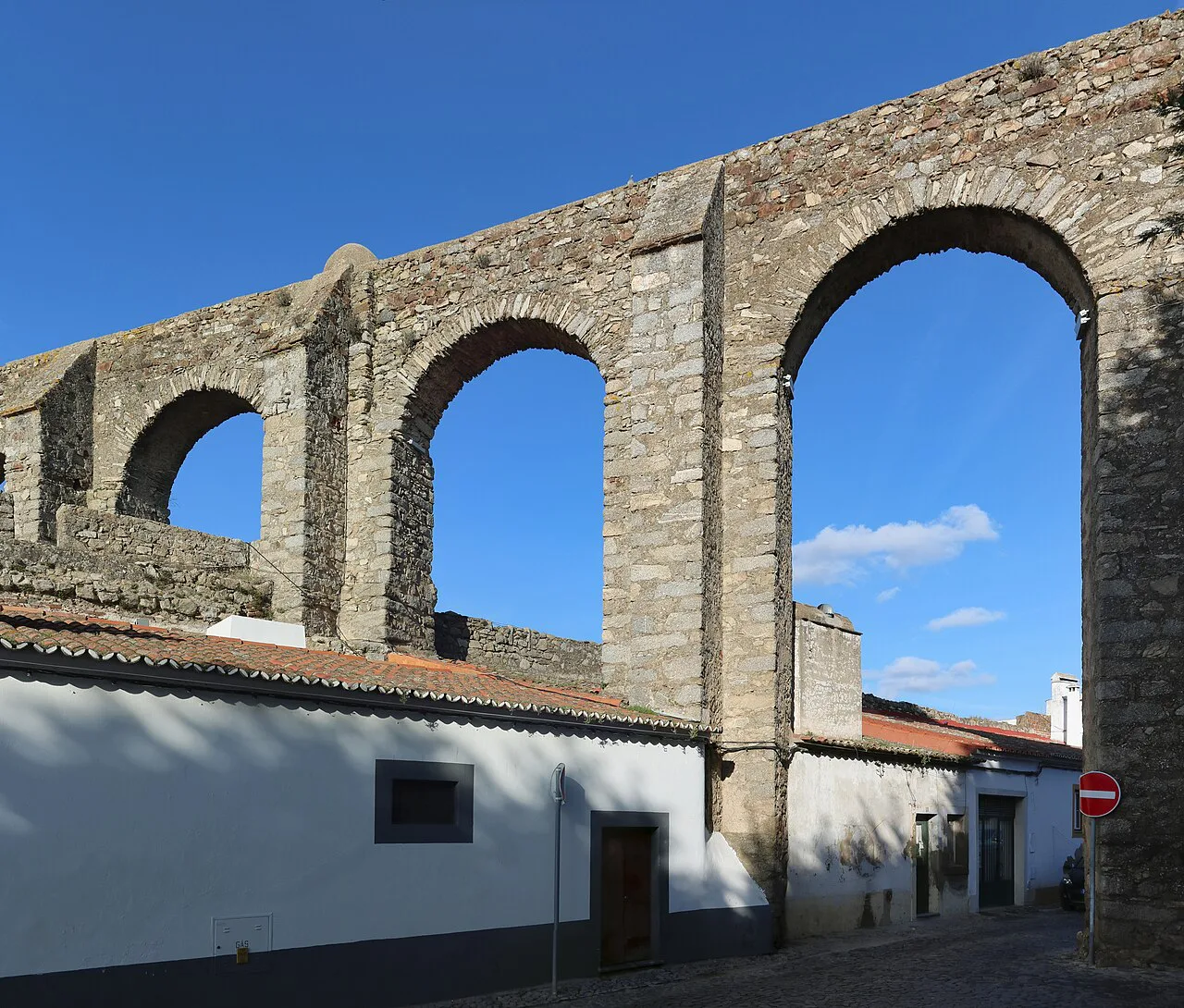 Arches of the aqueduct crossing Rua do Muro in Évora.
