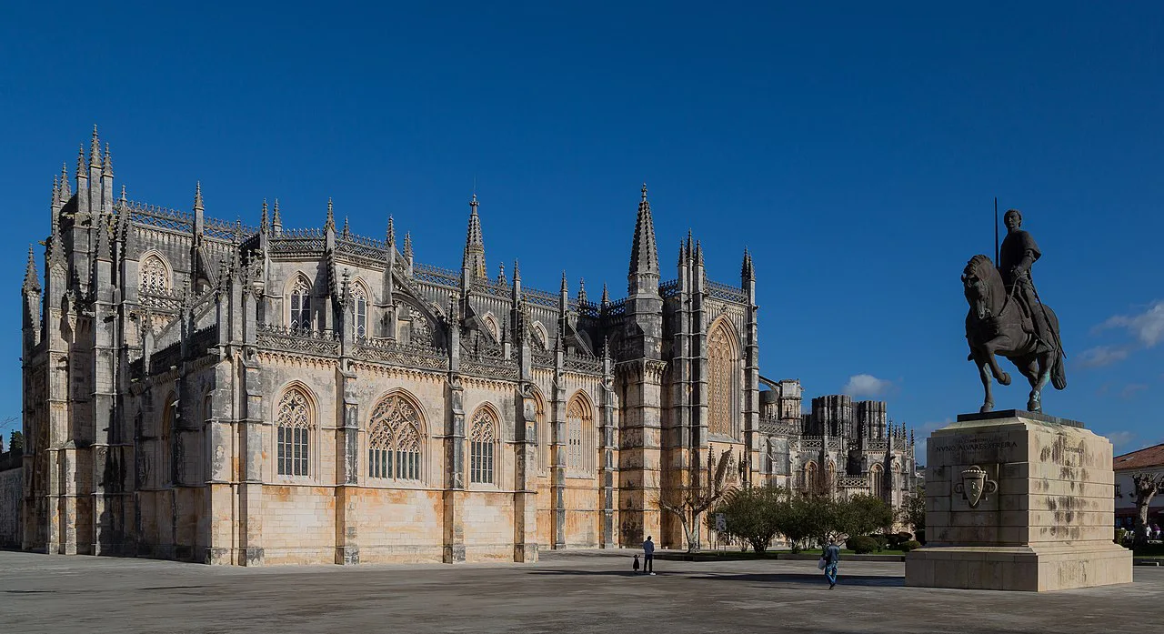 The Monastery of Batalha beside the equestrian statue of Nuno Álvares Pereira.