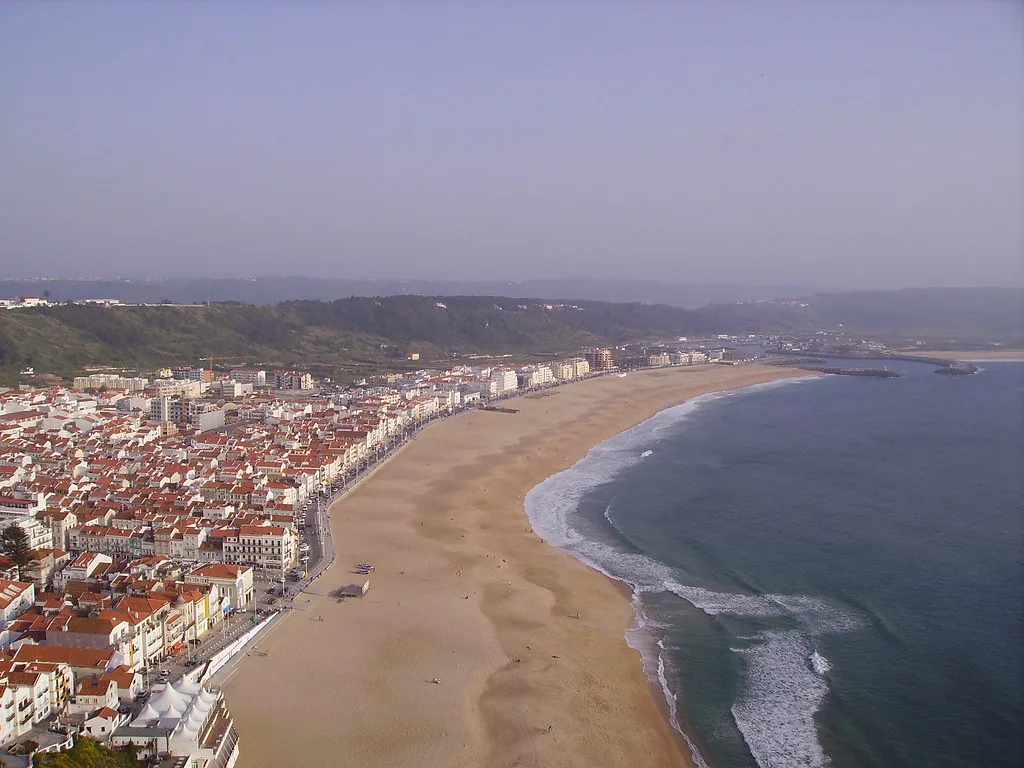 Nazaré's town and long sandy beach seen from the clifftop.