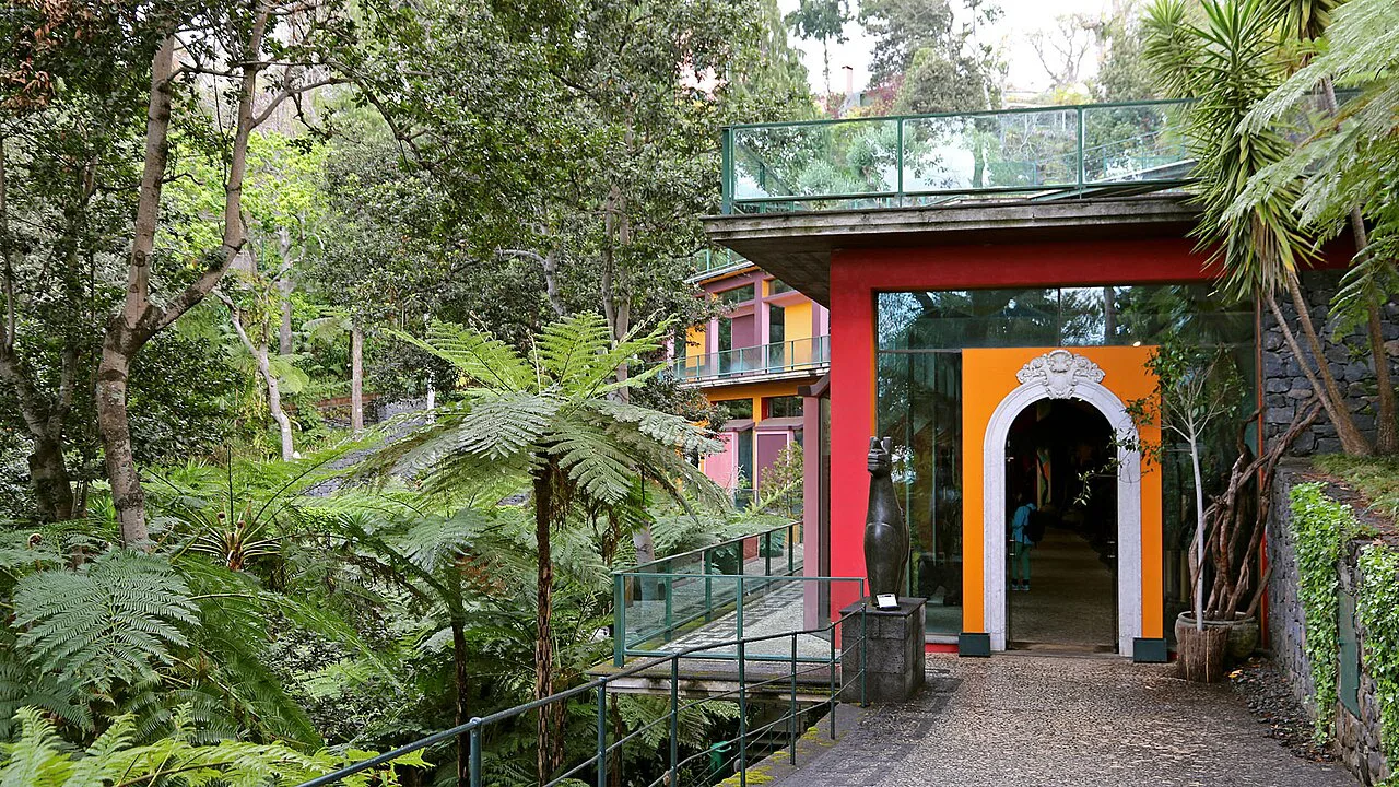 A red-and-orange gateway among the tropical planting of the Monte Palace Tropical Garden in Monte, Funchal.
